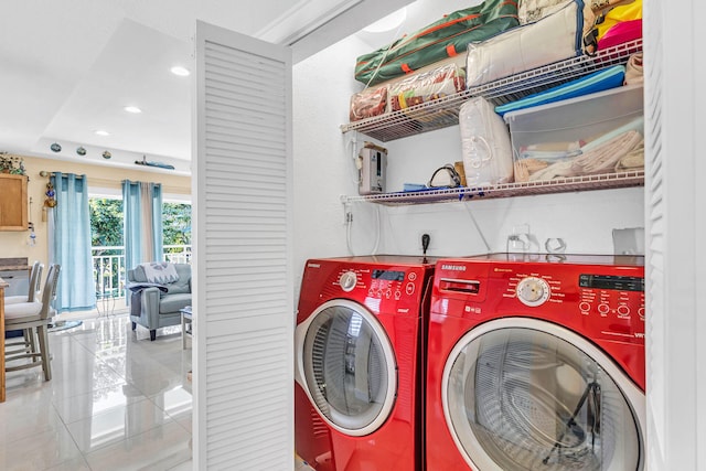 clothes washing area featuring light tile patterned floors and washing machine and clothes dryer