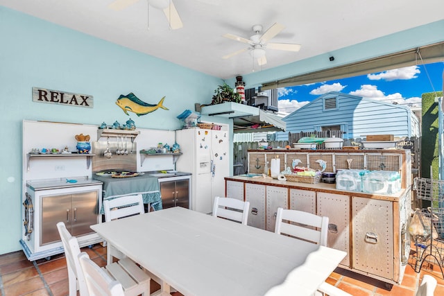 dining room featuring ceiling fan and tile patterned flooring