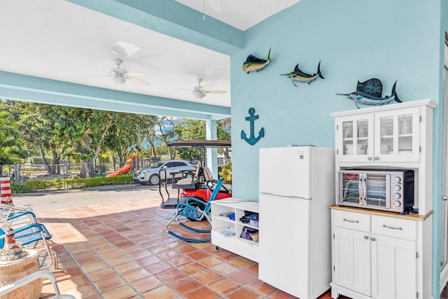 view of patio featuring ceiling fan