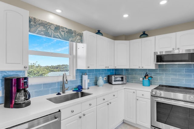 kitchen with white cabinetry, appliances with stainless steel finishes, and sink