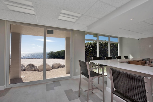 dining room featuring floor to ceiling windows and a paneled ceiling