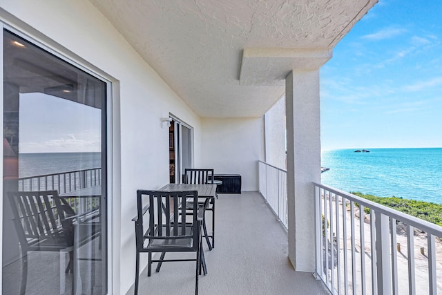 balcony featuring a water view