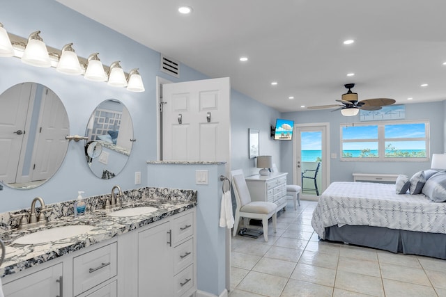 bathroom featuring tile patterned flooring, vanity, and ceiling fan