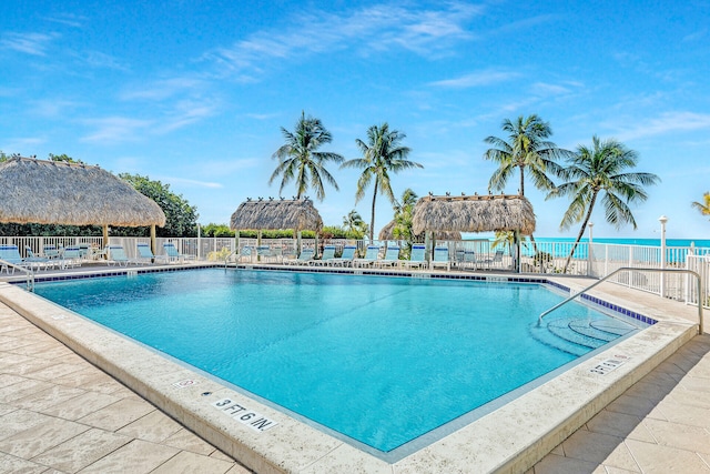 view of pool with a gazebo, a water view, and a patio area