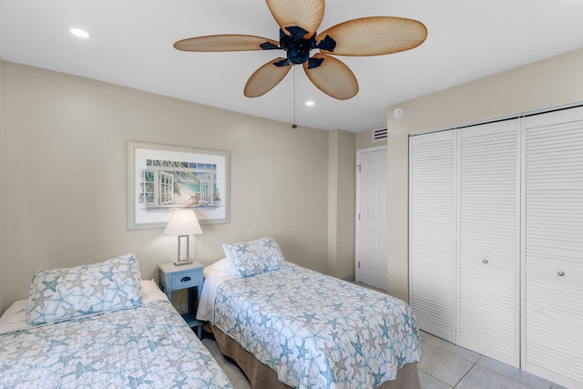 tiled bedroom featuring a closet and ceiling fan