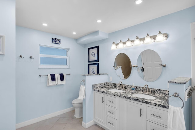 bathroom featuring vanity, tile patterned floors, and toilet