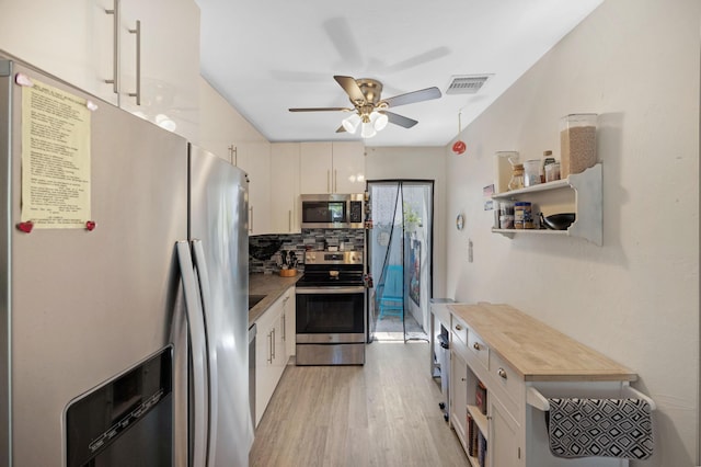 kitchen featuring visible vents, backsplash, light wood-style flooring, appliances with stainless steel finishes, and open shelves