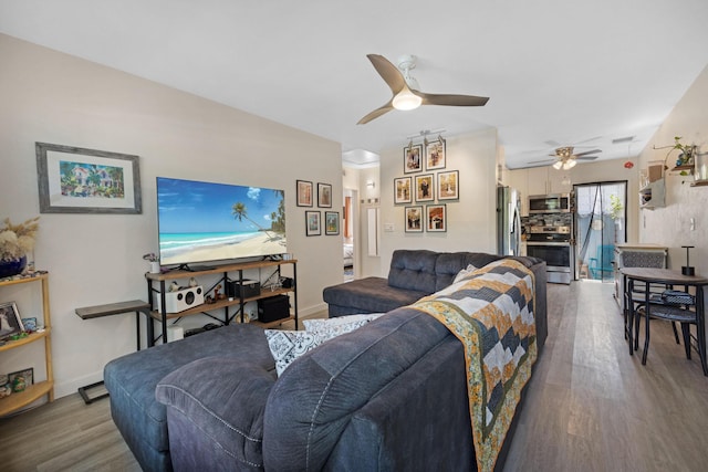 living area featuring wood finished floors, baseboards, and ceiling fan