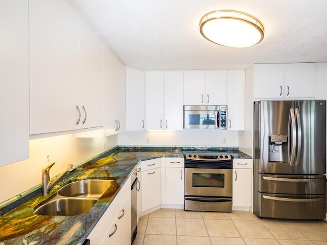 101 E Ocean Dr Unit C304, Key Colony, FL 33051 - kitchen featuring stainless steel appliances, sink, light tile patterned floors, and white cabinets