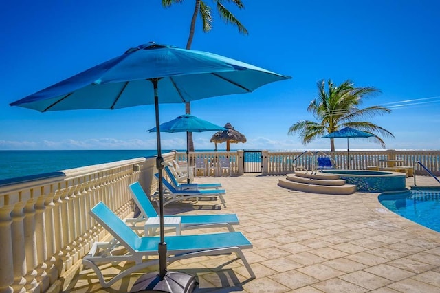101 E Ocean Dr Unit C304, Key Colony, FL 33051 - view of swimming pool featuring a hot tub, a patio, and a water view