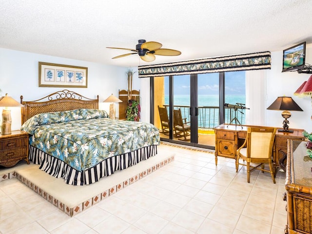 101 E Ocean Dr Unit C304, Key Colony, FL 33051 - tiled bedroom featuring ceiling fan, access to exterior, and a textured ceiling