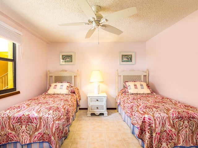 101 E Ocean Dr Unit C304, Key Colony, FL 33051 - tiled bedroom featuring ceiling fan and a textured ceiling