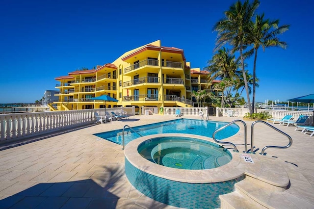 101 E Ocean Dr Unit C304, Key Colony, FL 33051 - view of swimming pool featuring a hot tub and a patio area