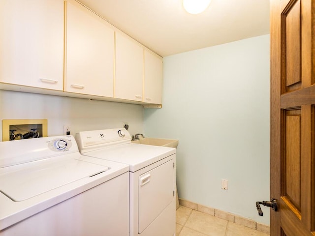 101 E Ocean Dr Unit C304, Key Colony, FL 33051 - laundry room with cabinets, light tile patterned flooring, sink, and washing machine and clothes dryer