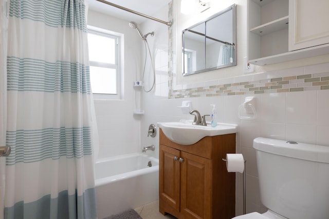 full bathroom featuring vanity, shower / tub combo, toilet, and tile walls