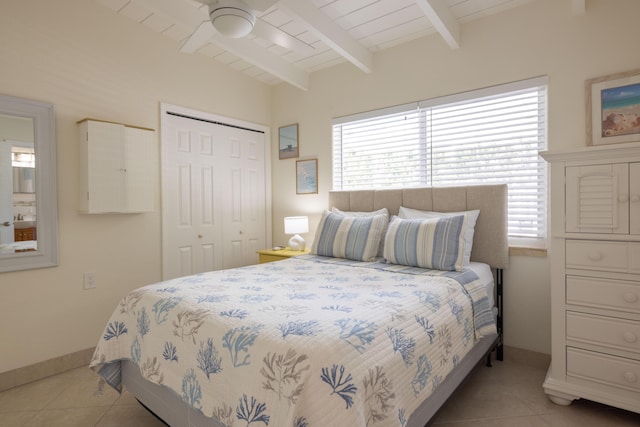 bedroom with light tile patterned flooring, lofted ceiling with beams, wooden ceiling, a closet, and ceiling fan