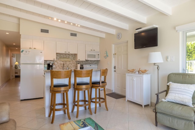 kitchen with white cabinetry, light tile patterned floors, backsplash, and white appliances