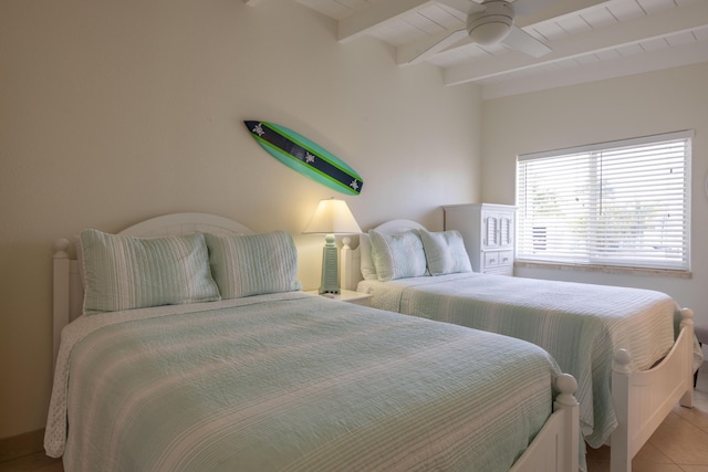 bedroom featuring beamed ceiling, light tile patterned floors, and ceiling fan