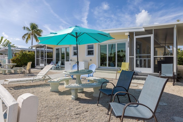 back of house with a sunroom and a patio area