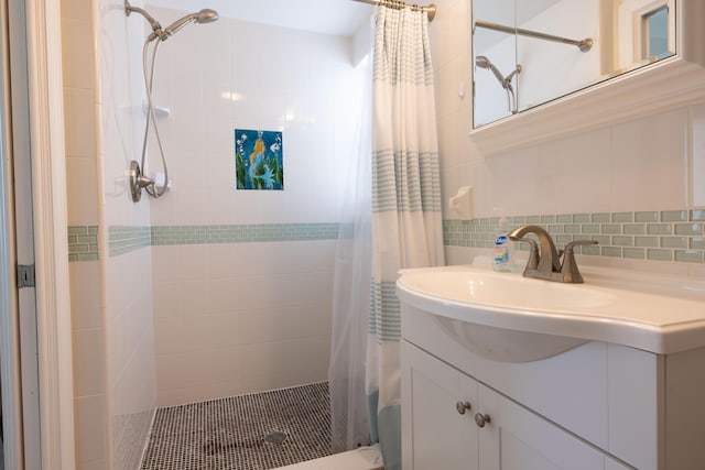 bathroom featuring walk in shower, vanity, tile walls, and backsplash