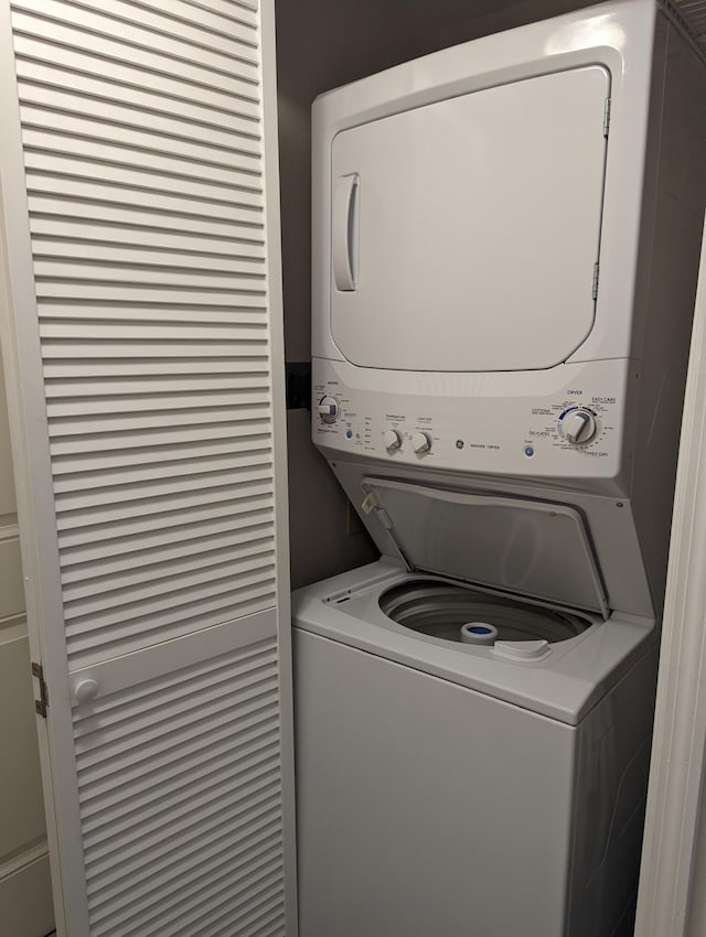 washroom with stacked washer / drying machine