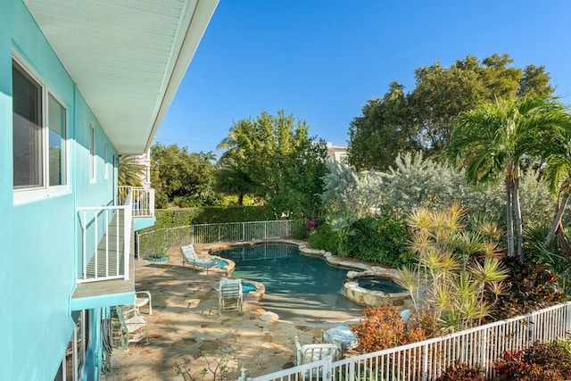 view of pool featuring a patio and an in ground hot tub