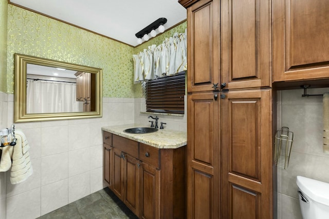 bathroom with vanity, tile walls, and toilet