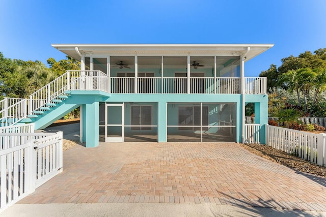 rear view of property with a patio area, a sunroom, and ceiling fan