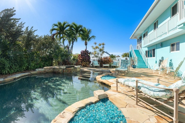 view of swimming pool featuring an in ground hot tub and a patio area