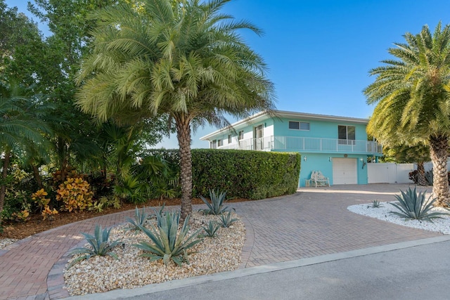 view of front of property with a balcony and a garage