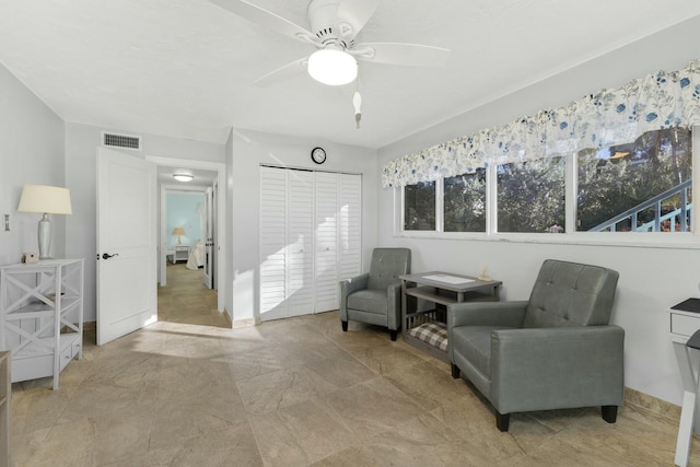 sitting room featuring ceiling fan