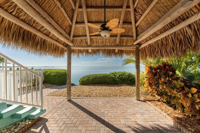 view of patio featuring a gazebo, a water view, and ceiling fan