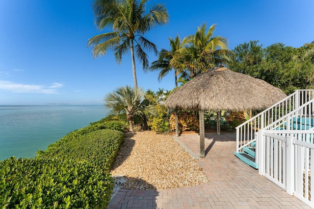 view of patio featuring a gazebo and a water view