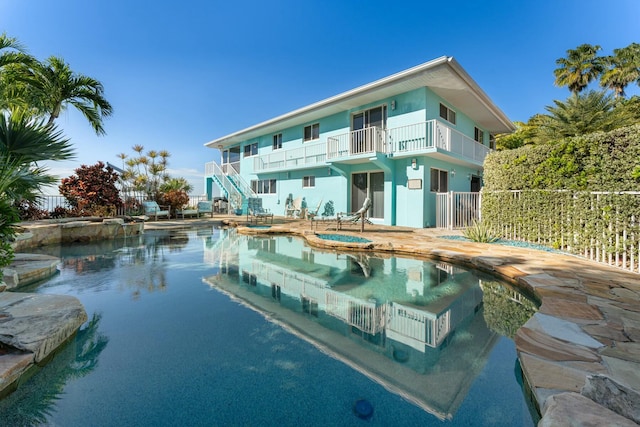 view of pool with an in ground hot tub