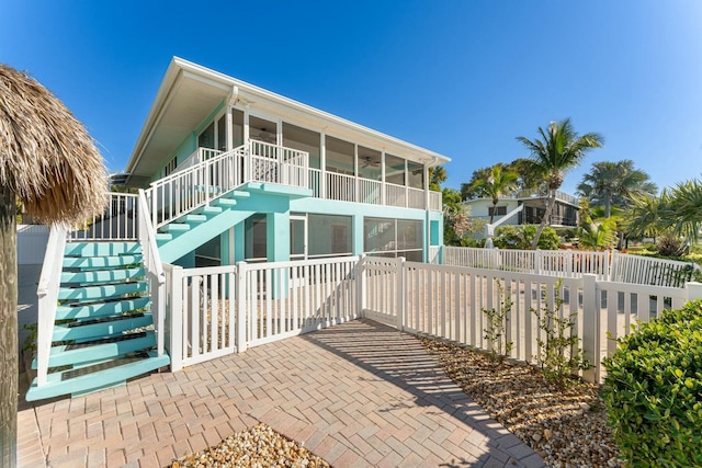 back of house featuring a sunroom