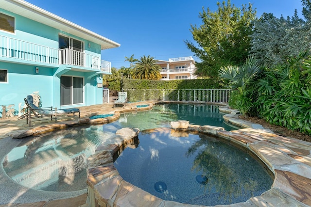 view of swimming pool featuring an in ground hot tub and a patio