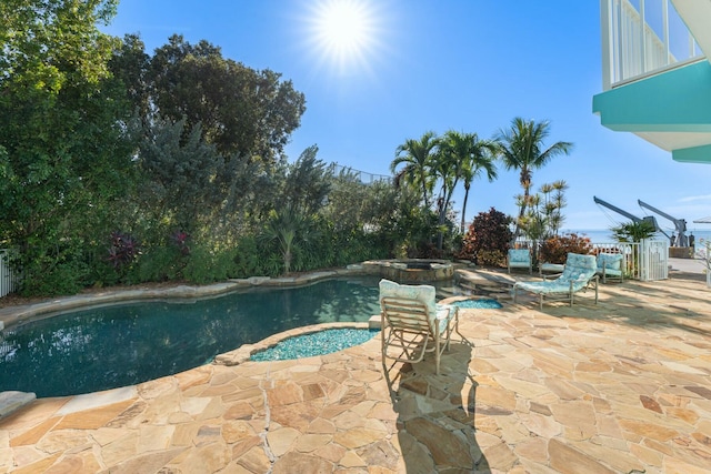 view of swimming pool with a patio area and an in ground hot tub