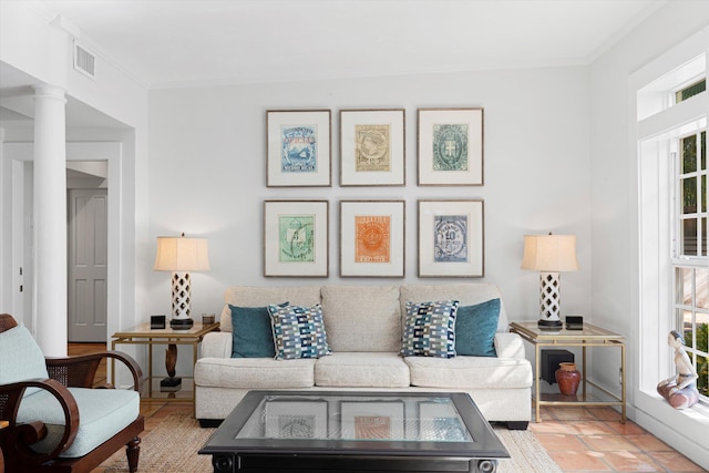 living room with ornamental molding and decorative columns