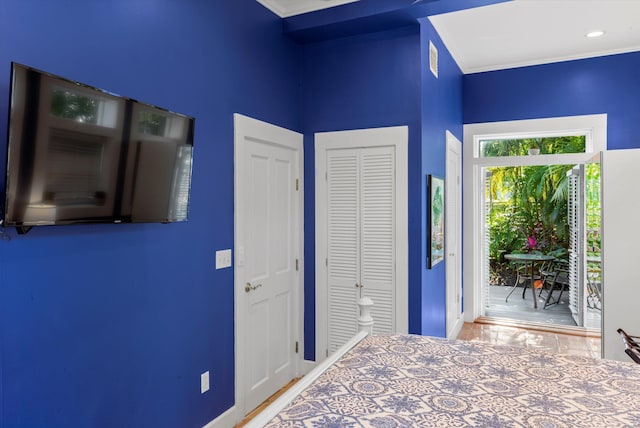 unfurnished bedroom with ornamental molding and a closet