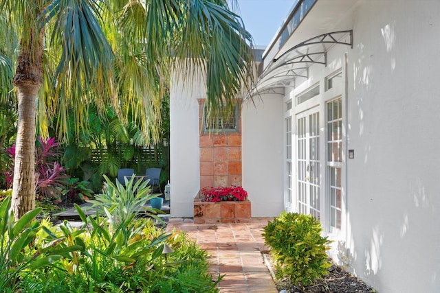 property entrance featuring a patio area and french doors