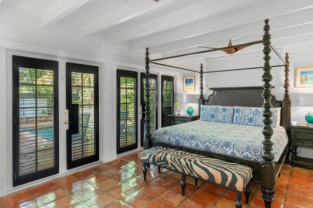 tiled bedroom with access to exterior and beamed ceiling