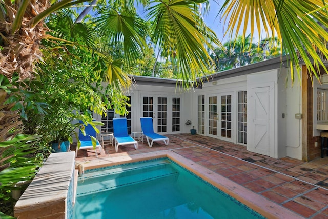 view of pool featuring a patio area and french doors