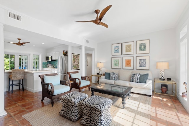 living room with tile patterned floors and ceiling fan