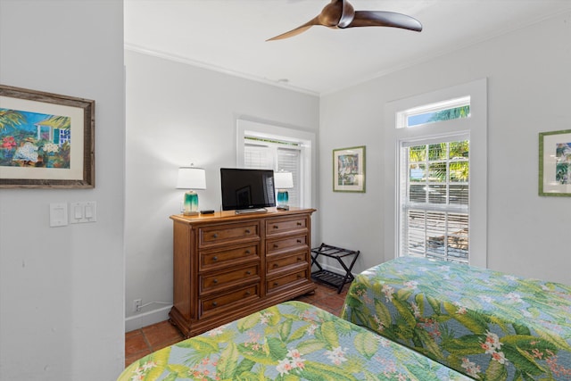bedroom featuring tile patterned floors, ornamental molding, baseboards, and ceiling fan