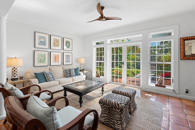 tiled living room with french doors, ceiling fan, and decorative columns