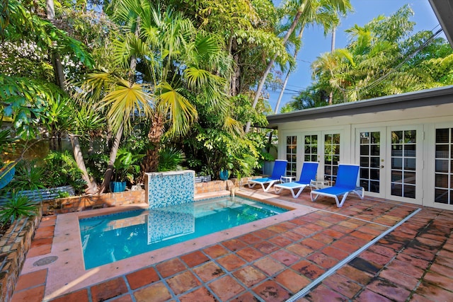 view of swimming pool featuring french doors and a patio