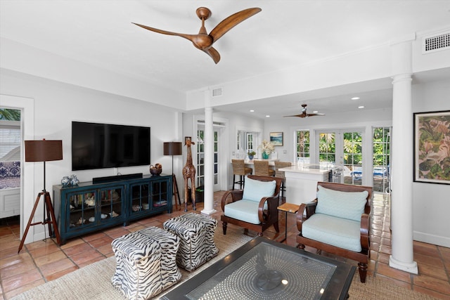 living room featuring french doors, ceiling fan, and ornate columns