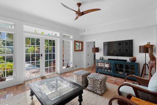 tiled living room featuring french doors, ceiling fan, and a healthy amount of sunlight