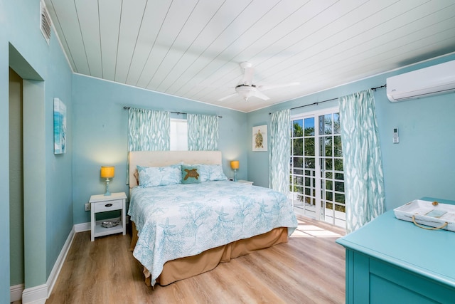 bedroom featuring access to exterior, ceiling fan, wooden ceiling, a wall unit AC, and light hardwood / wood-style flooring