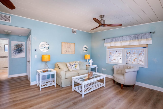 living room with hardwood / wood-style flooring and ceiling fan